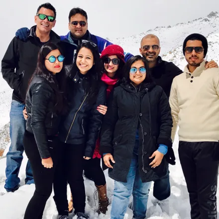 Small group of FinEdge team members posing together in a snowy mountain landscape.