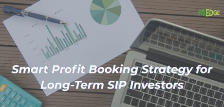 Flat lay of a laptop, printed pie and bar charts, pen and calculator illustrating a smart profit booking strategy for long‑term SIP investors