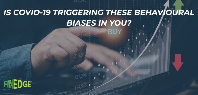 Investor behavioral biases during COVID-19 pandemic – person pointing at stock market data with upward and downward trends on screen